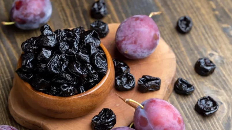 Black pile of prunes from a large number of ripe plums