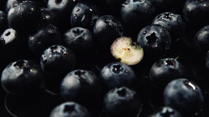 One halved blueberry and a bunch of blueberries