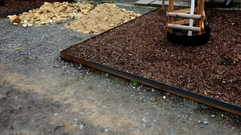 beds with trees and perennials mulched with wood chips