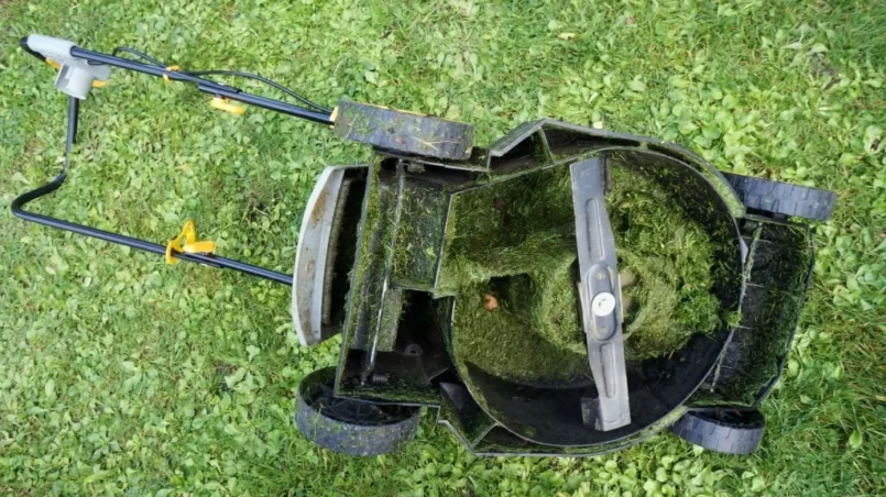 lawn mower's entire mechanism is clogged with wet cut grass