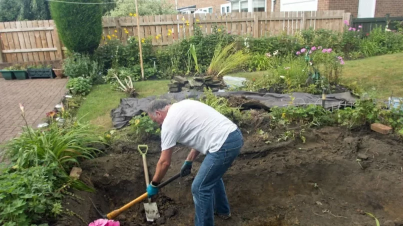 man reconstructing a pond