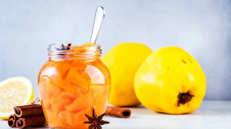 Autumn Quince jam or confiture in glass jar with cinnamon and anise