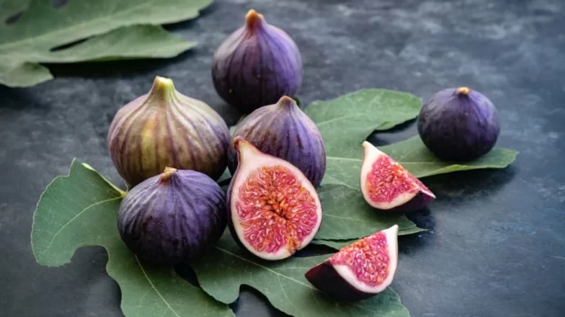 Whole and sliced figs on big fig leaves