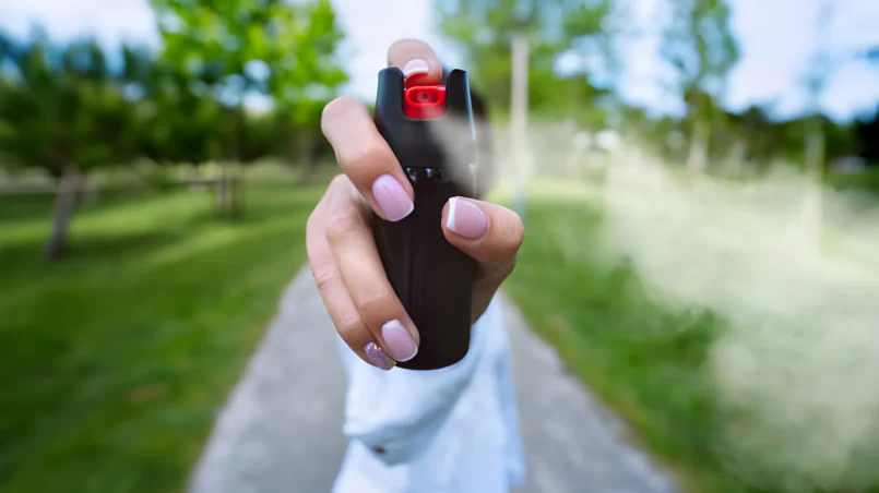 Woman using pepper spray